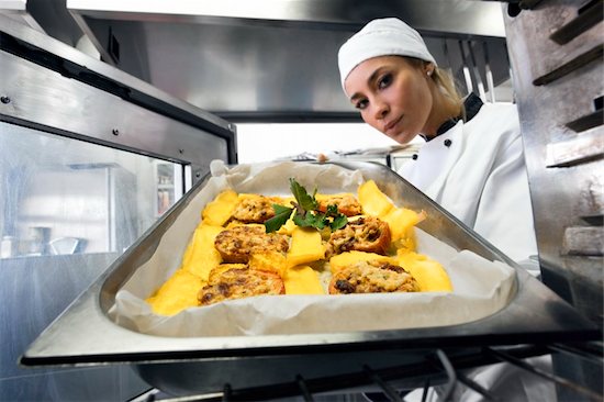 mid adult female chef putting baking-pan into oven Stock Photo - Royalty-Free, Artist: diego_cervo, Image code: 400-04588745