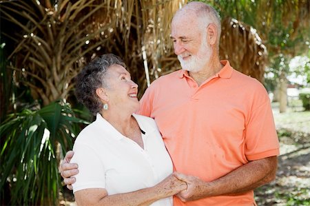 simsearch:400-05234340,k - Happy senior couple holding hands and looking into each others eyes. Stock Photo - Budget Royalty-Free & Subscription, Code: 400-04588827