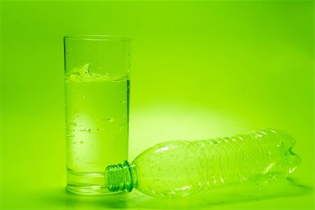 simsearch:400-05291556,k - Glass of water and empty bottle on green background Stock Photo - Budget Royalty-Free & Subscription, Code: 400-04588835