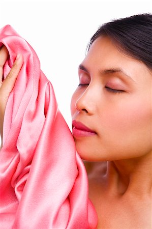 smelling laundry - Young woman smelling fresh pink satin with copy space on her left Stock Photo - Budget Royalty-Free & Subscription, Code: 400-04589365
