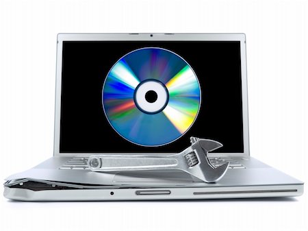 simsearch:400-05244427,k - Damaged laptop with a spanner over it and a digital disc on the screen. Isolated on white. Stock Photo - Budget Royalty-Free & Subscription, Code: 400-04589595
