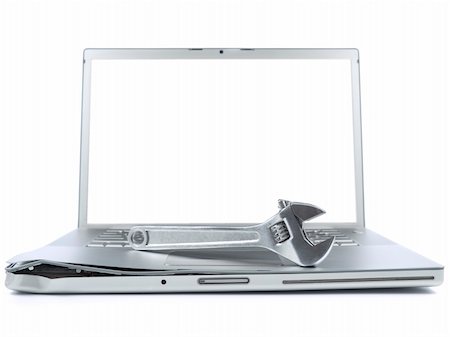 simsearch:400-05244427,k - A spanner over a damaged laptop isolated over white background. White copy space on screen. Stock Photo - Budget Royalty-Free & Subscription, Code: 400-04589596