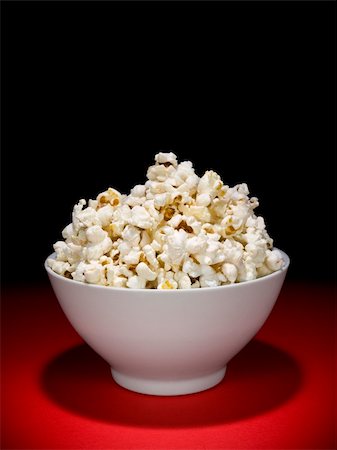 sweet and salty - A bow full of popcorn under the spotligh. Stock Photo - Budget Royalty-Free & Subscription, Code: 400-04589600