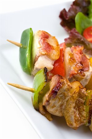 shashlik on a plate with a tomato and salad leaf Stock Photo - Budget Royalty-Free & Subscription, Code: 400-04589616