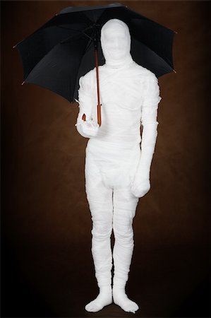 Mummy under umbrella on black background Stock Photo - Budget Royalty-Free & Subscription, Code: 400-04582522