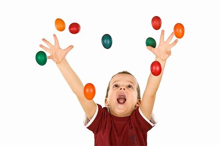 Happy boy shouting and reaching out for the falling colorful easter eggs - isolated, without motion blur Stock Photo - Budget Royalty-Free & Subscription, Code: 400-04594010
