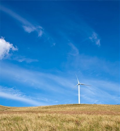 simsearch:400-04024418,k - Wind tower on a field with blue sky. Fotografie stock - Microstock e Abbonamento, Codice: 400-04594572