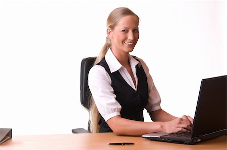 simsearch:400-04540351,k - A oung and pretty woman is working at a desk with her leptop and smiling. Stock Photo - Budget Royalty-Free & Subscription, Code: 400-04595289