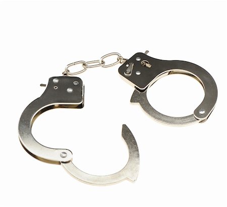 simsearch:400-05300234,k - Handcuffs. Iron handcuffs isolated on a white background Fotografie stock - Microstock e Abbonamento, Codice: 400-04596468