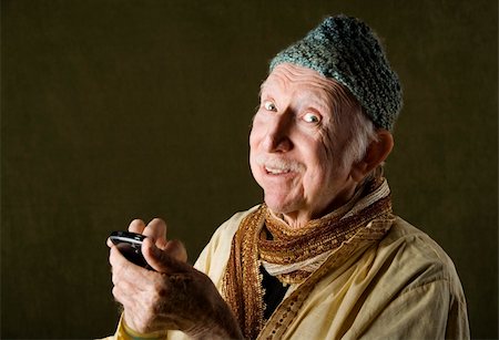 simsearch:400-04596625,k - Wise Man with Knit Cap Talking on Cell Phone Stock Photo - Budget Royalty-Free & Subscription, Code: 400-04596624