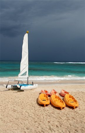 punta cana - A catamaran and six plastic canoes sitting on shore at the beach. Stock Photo - Budget Royalty-Free & Subscription, Code: 400-04596683