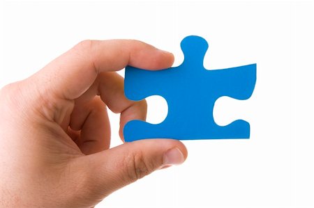 simsearch:640-01355058,k - Hand holding a blue puzzle isolated on white Photographie de stock - Aubaine LD & Abonnement, Code: 400-04596822