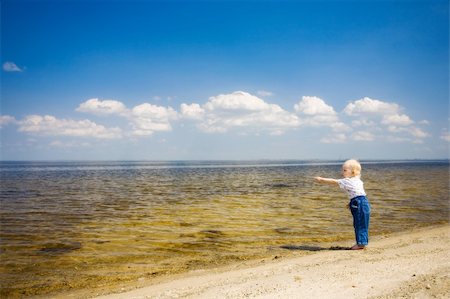 simsearch:400-04596901,k - small girl points away near the river Stock Photo - Budget Royalty-Free & Subscription, Code: 400-04596897