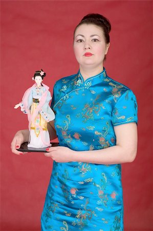 simsearch:400-05383537,k - Japanese girl with doll on the red background Stock Photo - Budget Royalty-Free & Subscription, Code: 400-04597569
