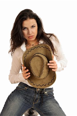 Half body view of young fashion model posing with white blouse, blue jeans and cowboy hat. Isolated on white background. Foto de stock - Super Valor sin royalties y Suscripción, Código: 400-04598161