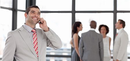 simsearch:400-04113098,k - Potrait of a Businessman on the phone in front of business team Stock Photo - Budget Royalty-Free & Subscription, Code: 400-04598681