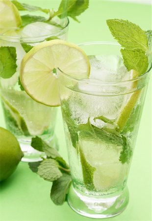 simsearch:400-07925229,k - Two mojito cocktails with lime, mint leaves and ice on green background Stock Photo - Budget Royalty-Free & Subscription, Code: 400-04598856