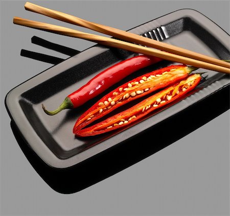 simsearch:400-05732421,k - fresh red chili peppers on a plate with chopstikcs over grey reflective surface Photographie de stock - Aubaine LD & Abonnement, Code: 400-04599038