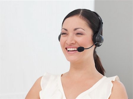 simsearch:400-03985399,k - International Business woman on a Headset smiling Photographie de stock - Aubaine LD & Abonnement, Code: 400-04599217
