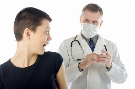 Doctor in gauze mask looks at a frightened woman while preparing a syringe Foto de stock - Super Valor sin royalties y Suscripción, Código: 400-04599819