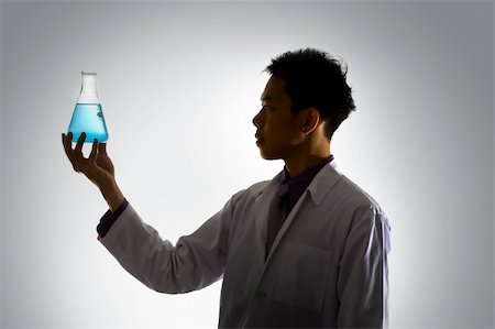 Silhouette of asian male scientist examining liquid in conical flask, side view Stock Photo - Budget Royalty-Free & Subscription, Code: 400-04590313