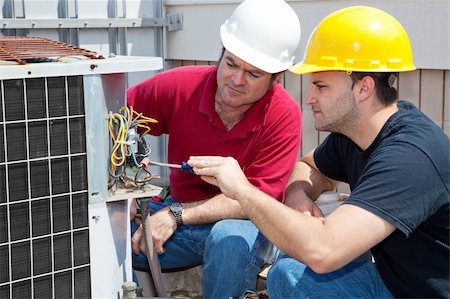 students working with tools - Vocational student learns air conditioning repair from an experienced instructor. Stock Photo - Budget Royalty-Free & Subscription, Code: 400-04590675