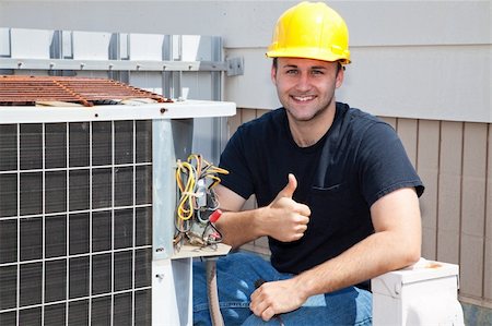 Air conditioning repairman working on a compressor and giving a thumbsup. Stock Photo - Budget Royalty-Free & Subscription, Code: 400-04590670