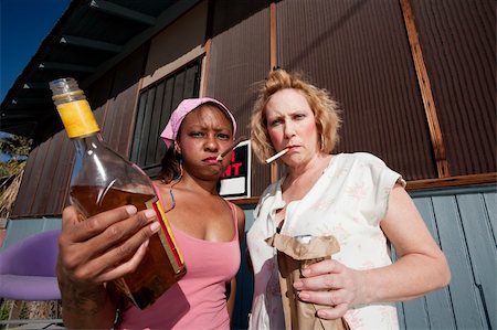 Portrait of two trashy drunk women outdoors Stock Photo - Budget Royalty-Free & Subscription, Code: 400-04591312