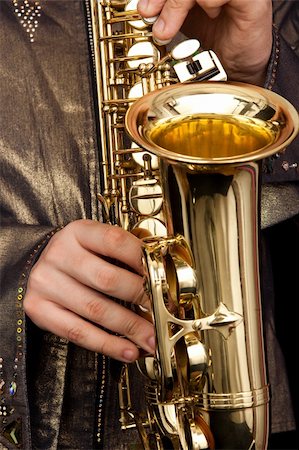 golden alto saxophone in hands of young man Stock Photo - Budget Royalty-Free & Subscription, Code: 400-04591387