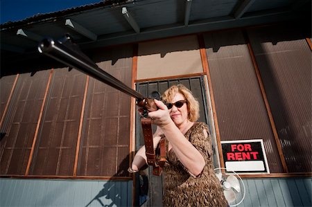 Blonde woman on her front porch with a rifle Photographie de stock - Aubaine LD & Abonnement, Code: 400-04591844