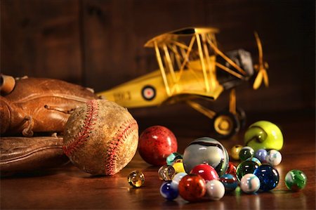 Old baseball and glove with antique toys on wood floor Stock Photo - Budget Royalty-Free & Subscription, Code: 400-04592536