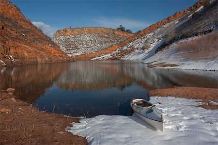 red canoe on lake - canoe and Colorado mountain lake (Horestooth Reservoir near Fort Collins)  in early spring with red sandstone cliffs and snow Stock Photo - Budget Royalty-Free & Subscription, Code: 400-04593458
