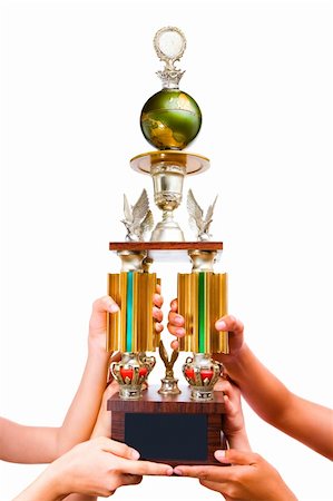 Three people holding the trophy together, showing only hands Stock Photo - Budget Royalty-Free & Subscription, Code: 400-04604114