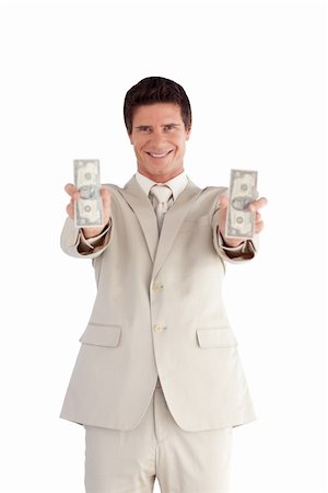 Attractive Businessman holding Dollars Stock Photo - Budget Royalty-Free & Subscription, Code: 400-04605011