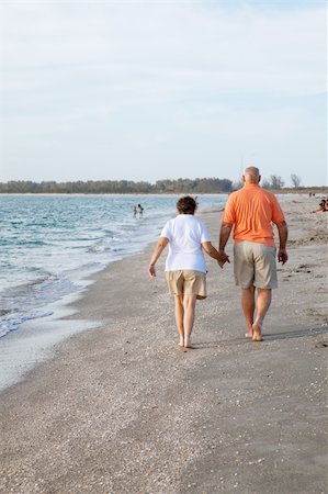 senior woman exercising by ocean - Rear view of senior couple walking on the beach. Stock Photo - Budget Royalty-Free & Subscription, Code: 400-04605052