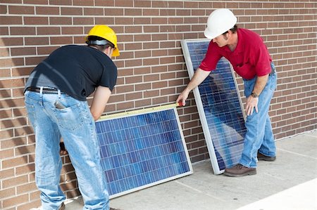 simsearch:400-04485314,k - Electricians measuring solar panels prior to installing them. Fotografie stock - Microstock e Abbonamento, Codice: 400-04605219