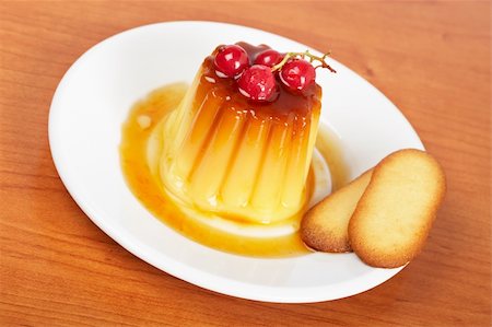 Vanilla cream caramel dessert with red currants and two cookies on white dish. Shallow depth of field Stock Photo - Budget Royalty-Free & Subscription, Code: 400-04605608