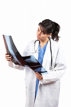 simsearch:400-06634198,k - Friendly female doctor in lab coat , examining x-ray against white background Stock Photo - Budget Royalty-Free & Subscription, Code: 400-04606572