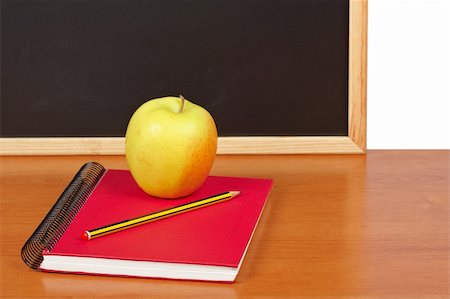 simsearch:400-03912552,k - A notebooks, pencil and yellow apple against black chalkboard. Shallow depth of field Stockbilder - Microstock & Abonnement, Bildnummer: 400-04606989