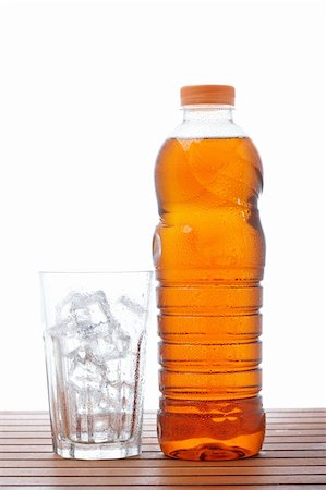 simsearch:400-06877048,k - A empty glass and bottle of ice tea on wooden background. Shallow depth of field Foto de stock - Royalty-Free Super Valor e Assinatura, Número: 400-04607144
