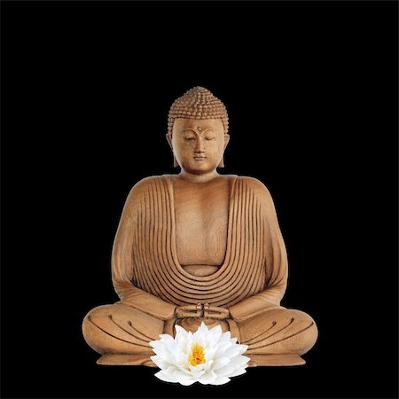 Buddha with eyes closed in prayer and a white japanese lotus lily flower, over black background. Stock Photo - Budget Royalty-Free & Subscription, Code: 400-04607403