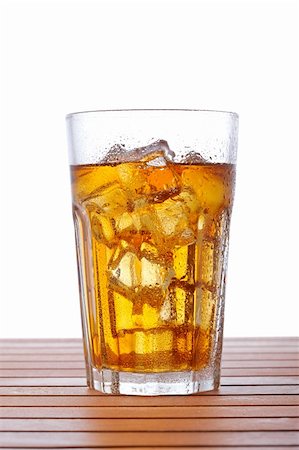 A glass of ice tea on wooden background. Shallow depth of field Stock Photo - Budget Royalty-Free & Subscription, Code: 400-04607547