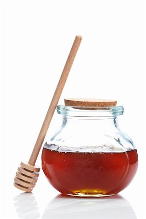 simsearch:400-08013853,k - Honey jar and wooden drizzler, reflected on white background Stock Photo - Budget Royalty-Free & Subscription, Code: 400-04607543