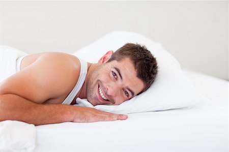 Handsome man lying in his bed smiling Stock Photo - Budget Royalty-Free & Subscription, Code: 400-04607566