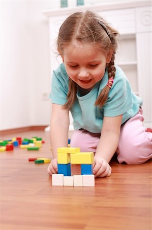 Adorable girl playing with blocks Stock Photo - Budget Royalty-Free & Subscription, Code: 400-04607582