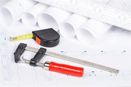 drafting tool - Construction plans with hard hat and tools. Shallow depth of field Stock Photo - Budget Royalty-Free & Subscription, Code: 400-04607733