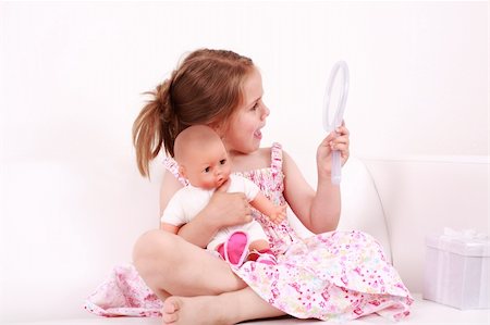 Beautiful small girl looking at the mirror Stock Photo - Budget Royalty-Free & Subscription, Code: 400-04607994