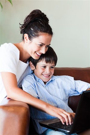 simsearch:400-04712944,k - Mother and son playing with a laptop on the couch Stock Photo - Budget Royalty-Free & Subscription, Code: 400-04608046