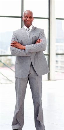 Smiling businessman with folded arms looking at the camera Stock Photo - Budget Royalty-Free & Subscription, Code: 400-04608040
