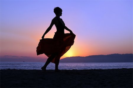 evening dress on beach - Woman walking on the beach at sunset Stock Photo - Budget Royalty-Free & Subscription, Code: 400-04608192